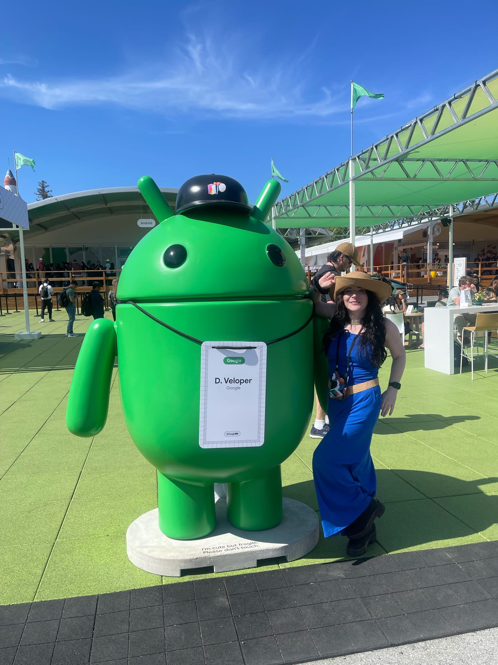 Andi Galpern at Google I/O standing beside a large green Android mascot statue
