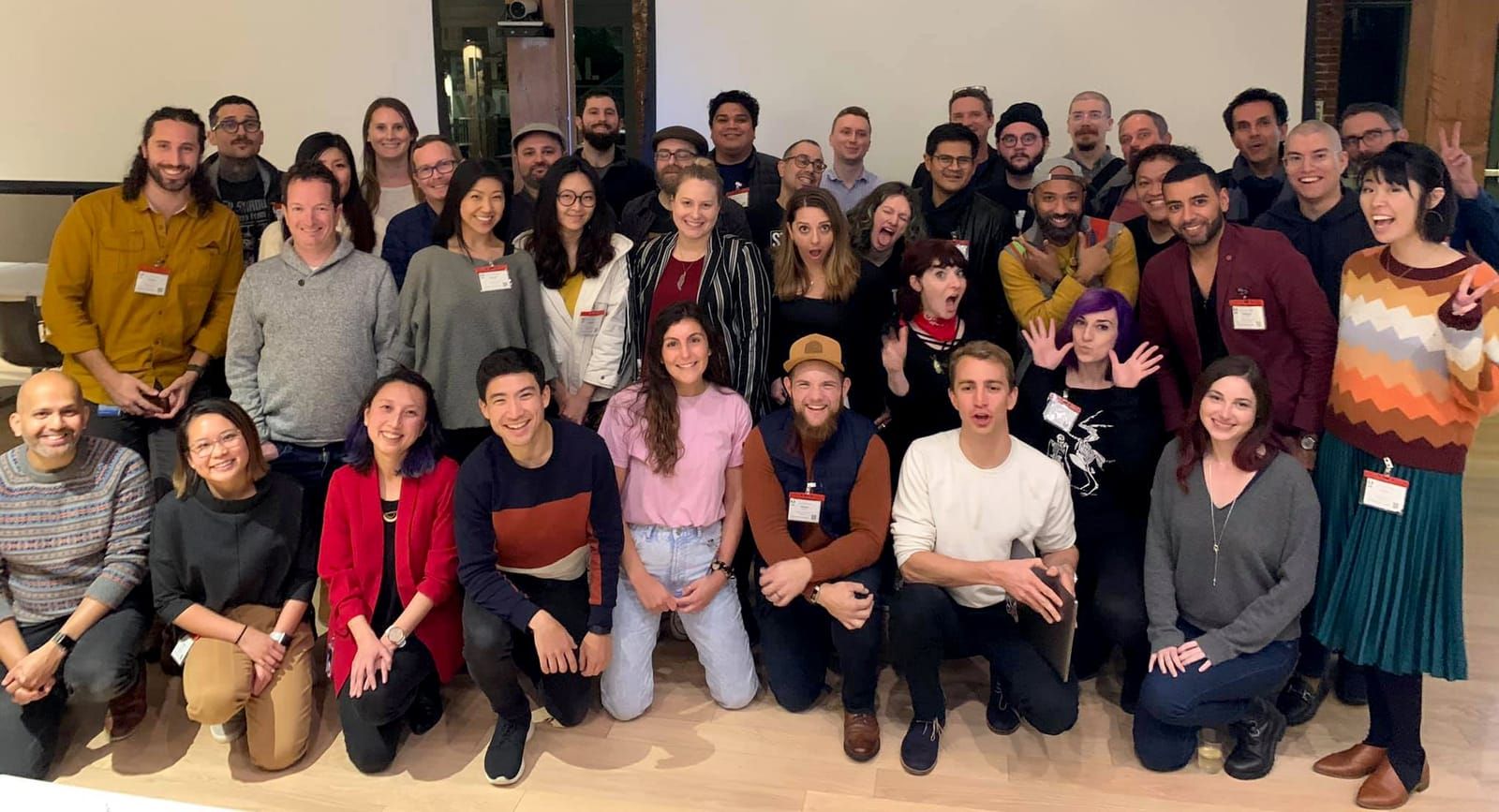 A large group of mentors and designers posing together for a photo at Mentor Night, hosted at Adobe's headquarters